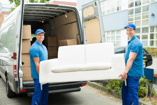 Team member loading boxes safely into a van